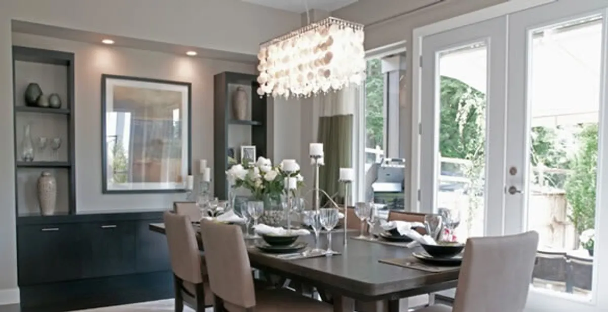 Elegant dining room chandelier installation above table in Baton Rouge, LA